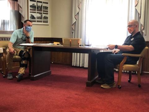 Lorrie Ross• Clay County Progress Two of Hayesville's council members look over the financial report at the August 10 meeting. Will Penland is on left with Austin Hedden on right.