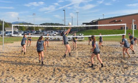 (Travis Dockery • Clay County Progress) The volleyball squads from Hayesville High School swarm the newly-finished outdoor court at the Clay County Recreation Center. 