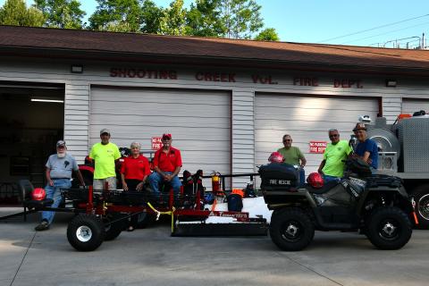 Shooting Creek members, from left, Jon Ashe, Joe Davenport, Lynn Trocchia, Pete Trocchia, Stanley Robinson, Tom Bussolari and Wade Moss admire the new rescue ATV and stokes basket trailer.