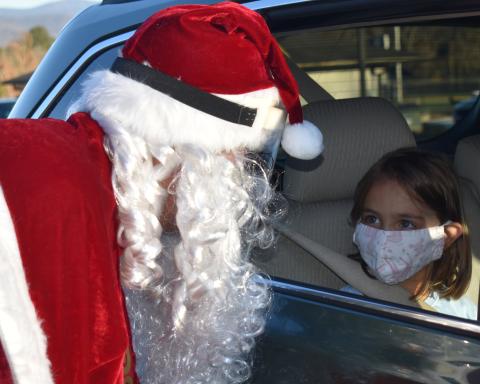 Lotte Jones, 5, gazes into Santa’s eyes during his recent visit to the Clay County Schools campus. Like Jones, numerous children greeted the jolly good man via a drive-thru visit hosted by the school. They received treats and dropped off their wish lists. Santa shared his list with the newspaper this week. Letters to Santa from our schools’ Pre-K through second grades appear in this edition’s C section, along with more photos from the drive-thru visit with Santa.