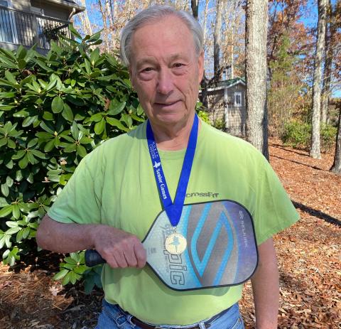 Travis Dockery • Clay County Progress Pickleballer Fred Sickel shows off his Senior Games gold medal and the paddle that helped him earn it.