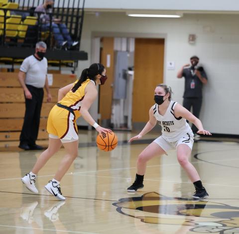 (Kelli Graves • Clay County Progress) Senior Kynnly McClure meets a Lady Brave at half court as Hayesville takes on Cherokee.