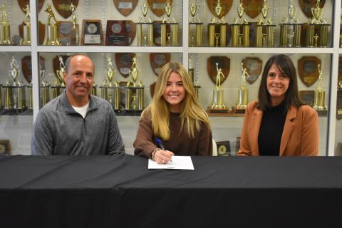 (Photo by Travis Dockery/ Clay County Progress) Jala Stamey, flanked by father Jeff and mother Jill, prepares to sign to play golf for Truett- McConnell University.