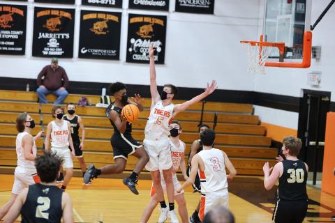 (Kelli Graves • Clay County Progress) Freshman Asher Brown takes flight and dishes a pass to an awaiting teammate under the basket.