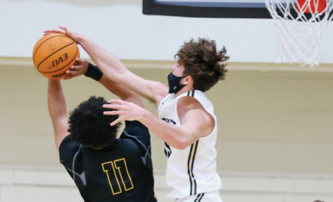 (Kelli Graves • Clay County Progress) Brady Shook takes flight and stops a Bulldog’s shot mid-air during Friday’s rivalry game.