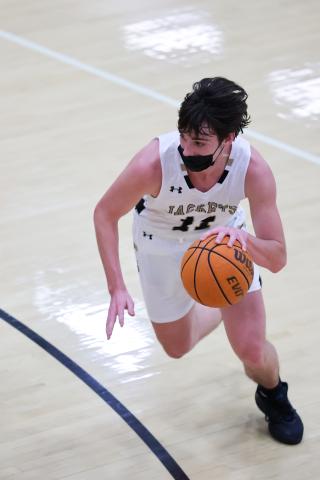(Kelli Graves • Clay County Progress) Senior Paul White starts a drive from the top of the key
