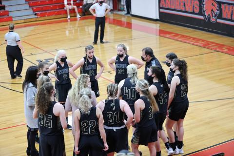 (Kelli Graves • Clay County Progress) Coach Chad McClure and his staff take advantage of a mask timeout to go over the game plan against the Lady Wildcats.