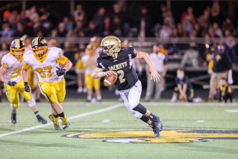 (Kelli Graves • Clay County Progress) Quarterback Logan Caldwell shows off his fancy foot work as he gains yards. 