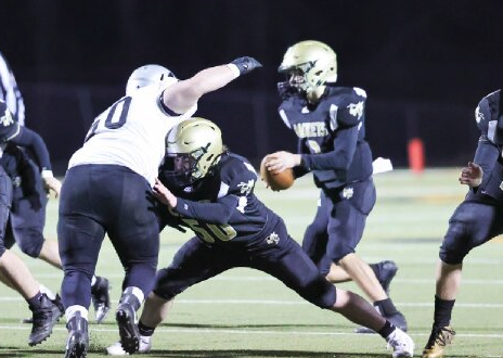 (Kelli Graves • Clay County Progress) Seth McCaslin does his best to create time for quarterback Logan Caldwell.