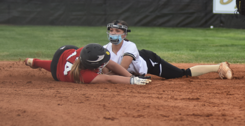 (Travis Dockery • Clay County Progress) Jayden Moore applies the tag to stop a Lady Wildcat from reaching second base.