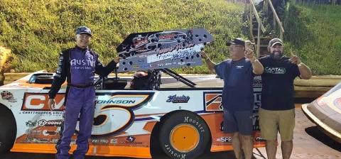 The “Chattanooga Flash” Ronnie Johnson, left, and his crew celebrate the main event win at Tri County Racetrack. 