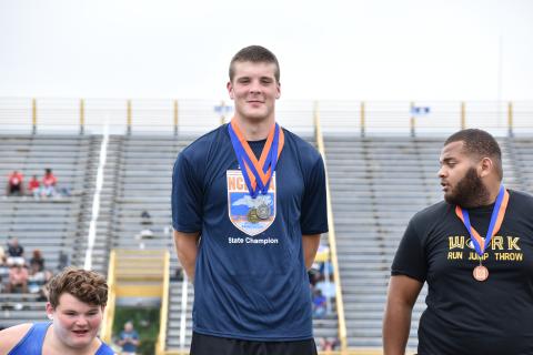 (Kevin Hensley • Graham Star) Jake McTaggart stands atop the podium with his gold medal for discus and silver medal for shot put.