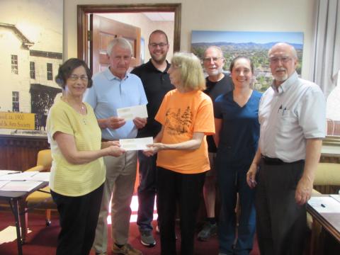 Receiving Town of Hayesville non-profit grant awards Monday night were Sara Smith, Paul Price and Reba Beck. Standing left to right are Smith, Price, Councilman Austin Hedden, Beck, Councilman Joe Slaton, Councilwoman Lauren Tiger and Mayor Harry Baughn.