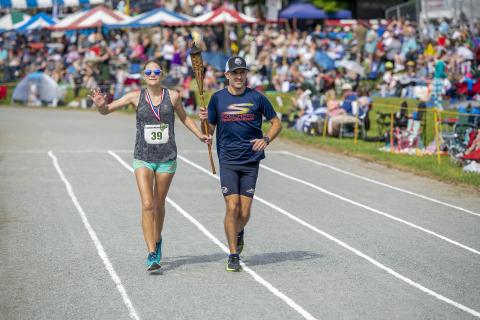 (Photo by Skip Sickler | Grandfather Mountain Stewardship Foundation)  Maggie Fortney and Caleb Masland make their victory lap at MacRae Meadows, site of the annual Grandfather Mountain Highland Games, after completing the 53rd Grandfather Mountain Marathon Saturday, July 10. Masland finished first with a time of 2:48:37.2, while Fortney was the first female finisher and ninth overall with a time of 3:31:18.6.