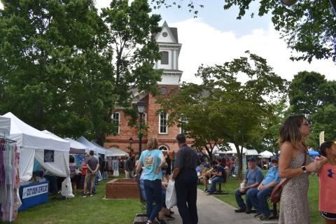 A large crowd enjoys the festive atmosphere on the square during the weekend celebration.