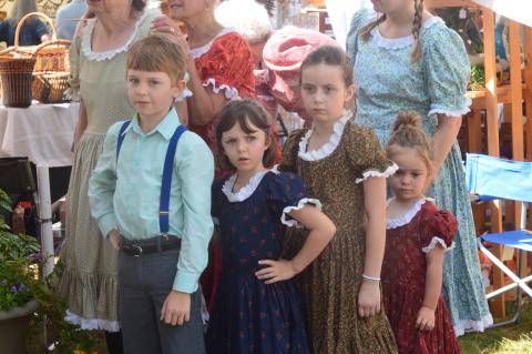 (Progress photo by Lorrie Ross)  Cloggers are a favorite for festival attendees. They will  take the gazebo stage at 10am Saturday morning. Cloggers from the John C. Campbell Folk School in Brasstown range in age from three years to 80 years old. For Festival 2019, some of the youngest dancers waited to take the stage, but also the hearts of those watching. L-R: Benjamin Davis, 8; Romaine Davis, 6; Jones Ference, 7; and three year old Ella Ference.