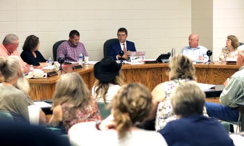 (Jared Putnam • Clay County Progress) Clay County School Superintendent Dale Cole, center, discusses social media standards while, from left, Board of Education members Danny Jones, Kelly Crawford, Chairperson Jason Shook, Vice-Chairperson Robert Caldwell and Reba Beck listen during the July meeting on Monday.