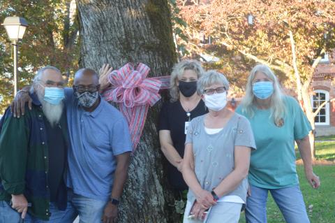 Lorrie Ross • Clay County Progress Some board members of People of Clay CARE stopped to pose for a picture during their ribbon tying on the Hayesville Square in October 2020. Red Ribbon Week is October 23 through October 31 and the group invites everyone to display a red ribbon on their door or front window. L-R: Board chairmen Daley Tucker, former board member and chair Harold Holbrook, founding member and board member Tanya Long, board member Terri Hager, and  board secretary Debbie Tucker.