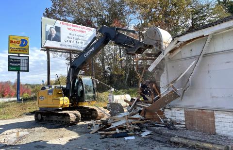 Workers tear down the Bid D Convenience Store at Old Highway 64 on Tuesday in Hayesville. 