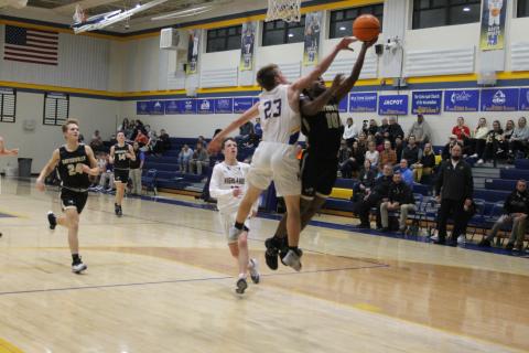Asher Brown skirts by a defender for a layup against Highlands.