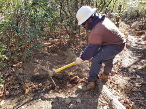 An ACE crew member improving trail conditions along the Mt. Mitchell Trail.