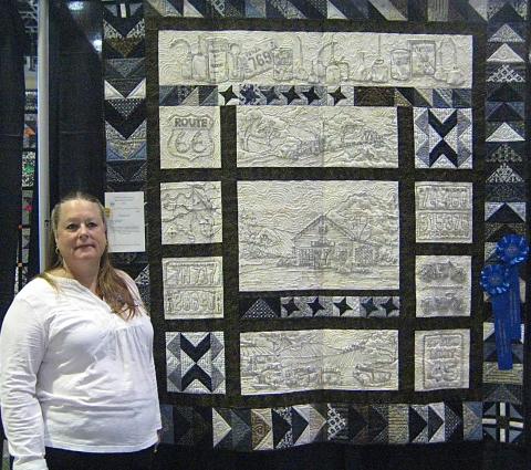 Audrey Bower with a blue-ribbon winning quilt.