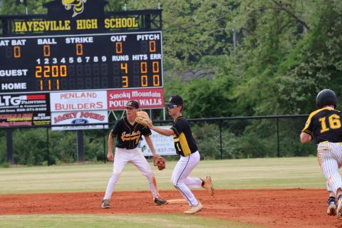 Mike Mauney and Dakota Matheson make a mad dash to second base as Bulldog runner breaks for a steal.