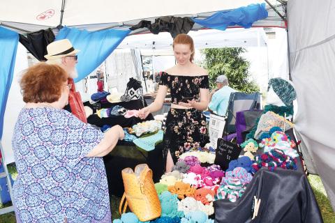 Brianna Ross enjoys chatting with customers during the Festival on the Square. Ross is owner of Boutique By Brianna. “It was great to see people get so excited about the products I put so much time and care into,” Ross said. “My stuffed bumblebees and octopuses were by far the best sellers this year, especially among kids and teens”