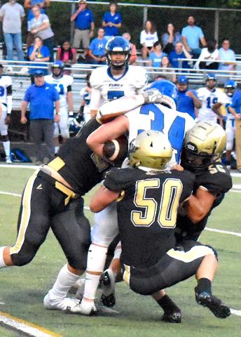 Gary Corsair • Clay County Progress Seth McCaslin, No. 50; Cameron Payne, No. 56 and Michael Mauney stop Georgia Force fullback Jordan Harrell, No. 34.