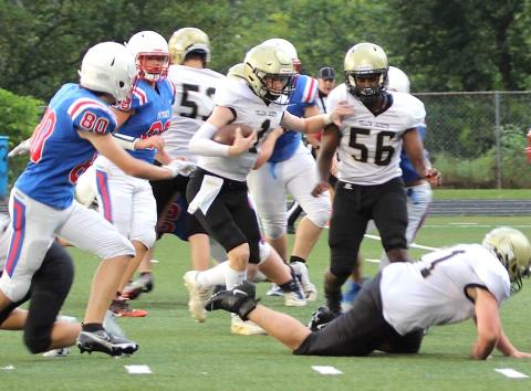 Kendra Coker • Photo Hayesville JV quarterback Peyton McGaha, 1, follows blockers Brendon Collins and Will Brown (56) up the middle for a big gain against Madison.