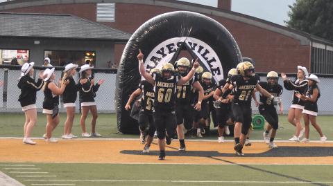 Gary Corsair • Clay County Progress Lane Odell, 61; Zek Furby, 71, and Maverick Imlay, 81, lead the Hayesville Yellow Jackets out of the tunnel and into the 2022 varsity football season.
