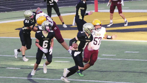 Photo •  Kendra Coker Hayesville JV quarterback Peyton McGaha, No. 1, heads for the endzone after faking a handoff to Tre Graves, No. 6, while E.J. Abrams, No. 51, blocks on the blind side.