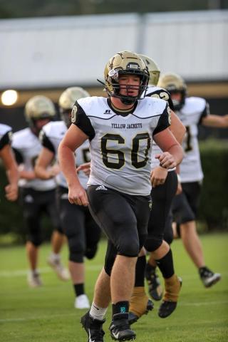 Photo • Asher Brown Lane O'Dell, No. 60, leads his teammates onto the field. Lane "The Train" also led the Yellow Jackets on the field of battle with outstanding blocking and bone-crunching tackling.