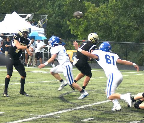 Logan Caldwell, No. 6, dumps a short pass over Towns County defenders while Kyle Lunsford, No. 7, provides protection.