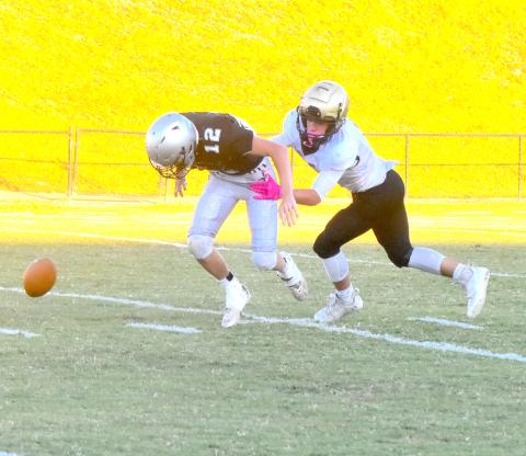 Gary Corsair •  Clay County Progress Robbinsville punt returner Tillman Adams coughs up the ball after being popped by Tre Graves. Will Brown recovered for Hayesville.