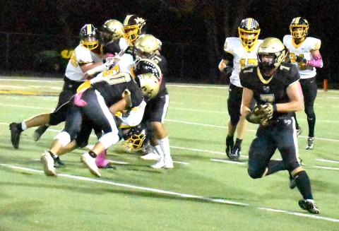 Gary Corsair • Clay County Progress Hayesville's Kyle Lunsford, No. 7, bolts for daylight after eluding two Murphy defenders.