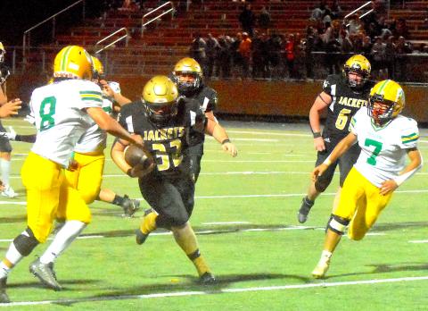 Gary Corsair • Clay County Progress  Yellow Jackets super sophomore Dawson “Freight Train” DeVane busts through a huge hole in the second half of Hayesville’s 37-22 playoff victory over Alleghany.