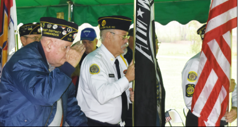 Becky Long • Progress American Legion Past District Commander and Clay County veteran Jack Greve salutes as Bill Thurman and other Color Guard members transport the flags for placement during the 11 a.m. Veterans Day ceremony.
