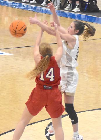 Hayesville's Ava Shook, No. 12, slips a pass through Polk County's zone defense.