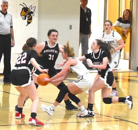 Gary Corsair • Clay County Progress  Hayesville's Ava Shook slips a pass through three Andrews defenders during the Lady Yellow Jackets Smoky Mountain Conference victory on Saturday.