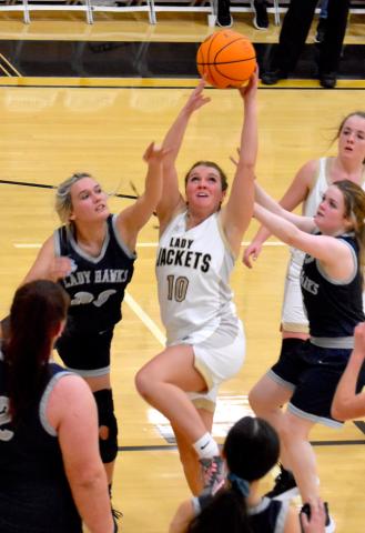 Gary Corsair • Clay County Progress Lakota Shelton, No. 10, keeps her eyes firmly fixed on the prize as she rebounds in traffic against Nantahala. Shelton plucked the Eagles for eight rebounds and 7 points, both career highs, as Hayesville rolled to a 68-22 win in The Hive on Monday night. That's Breanna Abrams watching her teammate get busy.
