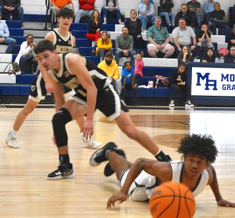 Gary Corsair • Clay County Progress Logan Caldwell, No. 2, and Ethan Hooper, No. 3, watch Mario Revels unsuccessful attempt to corral the basketball. 