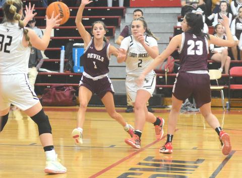 Gary Corsiar • Clay County Progress Hayesville senior Lila Roberts, No. 2, dishes to Bryleigh Krieger, No. 32, against Swain last week. 
