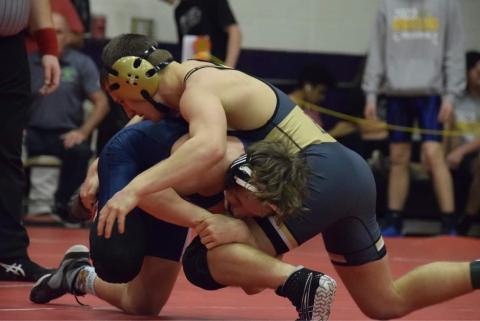 Photo by Jenny Millsaps Gage Michael in action with opponent at Regional Tournament.