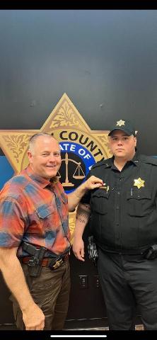 Officer Nick Queen, right, receives the Life Saving Commendation from Sheriff Mark Buchanan. Queen and Osborn  revived a man from an overdose, according to Buchanan.