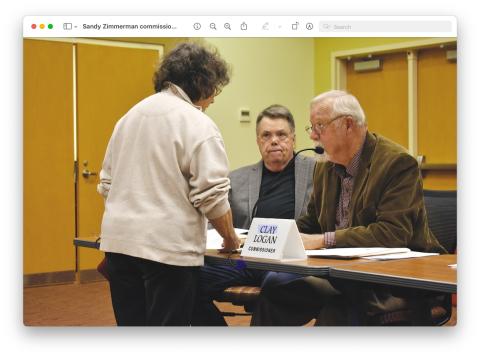 Sandy Zimmerman speaks with commissioners Scotty Penland, left, and Clay Logan prior to the March 2 meeting in the Clay County Courthouse. Zimmerman spoke during public comment recommending Town Council member Lauren Tiger for a seat on the Four Square Community Action Board of which she was appointed. Tiger will replace Logan who is coming off the board.