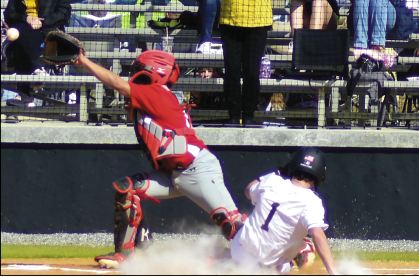 Gary Corsair • Clay County Progress Michael Mauney, No. 1, delights fans by sliding into the plate with an inside-the-park to put Hayesville up 1-0 against Andrews.