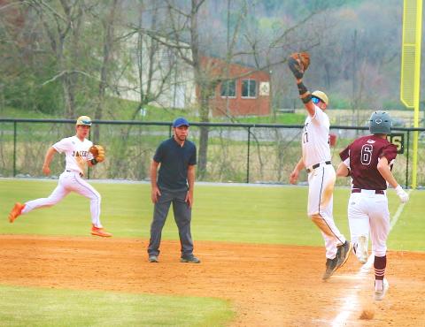 Photo by Brian Burch Hayesville first sacker Kyle Lunsford stretches to make a cutout against Swain as Michael Mauney races over to back up the play.