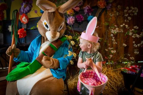 Robert Grand • John Campbell Folk School Madison Rose Handford is excited to see the Easter Bunny at the folk school. The rain did not stop the fun of the hunt.