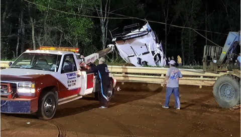 Travis Dockery • 389 Country Track officials work on recovering Logan Wall's car after a wild ride.